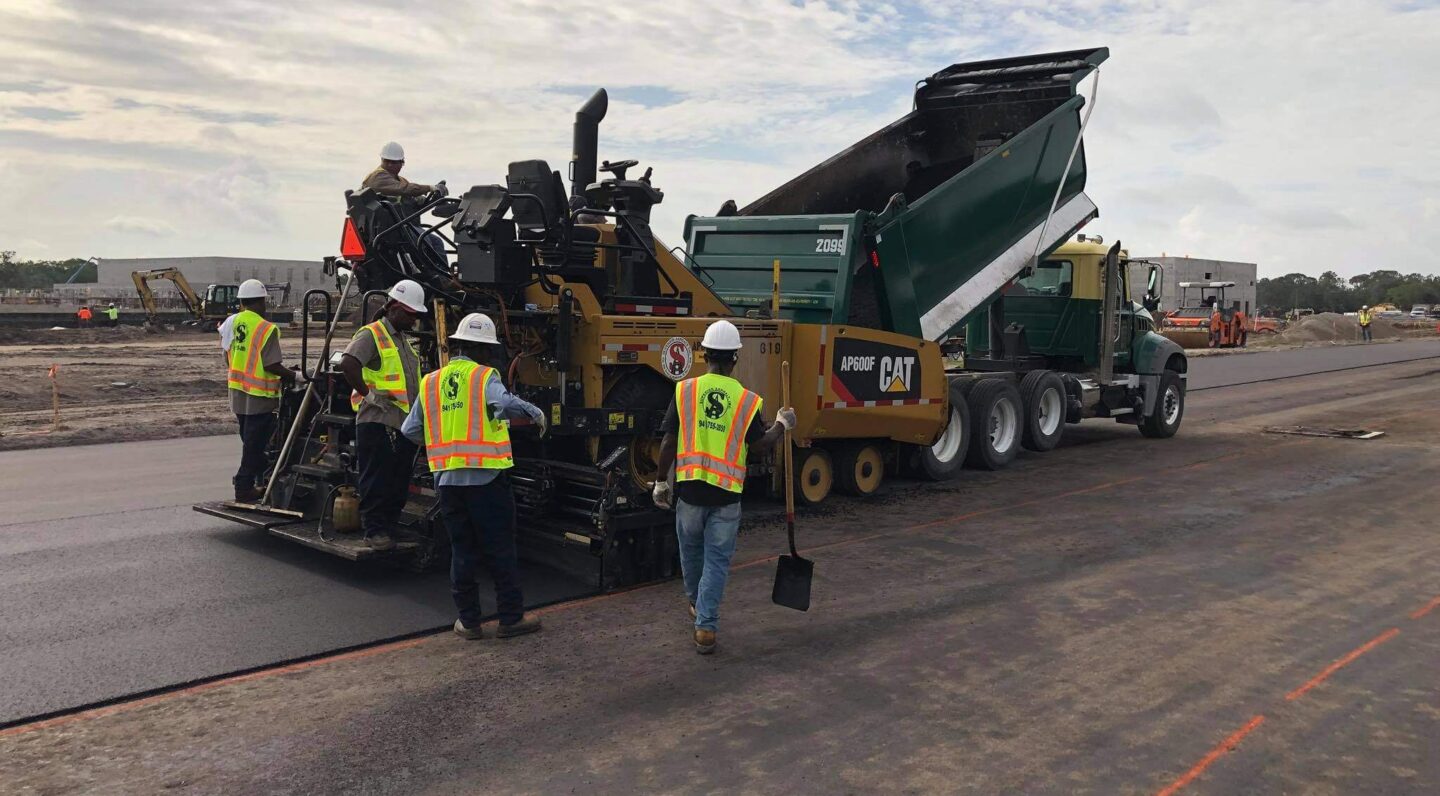 Paving team and dump truck